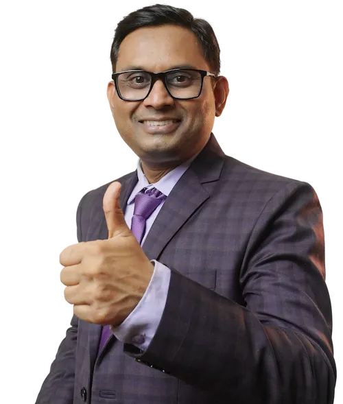 Ashish Mudra, India’s first Sales Transformation Coach, giving a confident thumbs-up gesture in a business suit.
